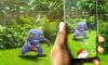 The featured image for our Pokemon Go Codes guide, featuring a point-of-view shot of someone trying to capture a Pokemon in their backgarden.
