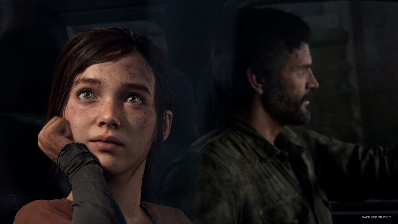 The featured image for our The Last Of Us part 1 PC requirements guide, featuring a screenshot of the game. Ellie and Joel are in a car, and Ellie looks outside of the car, towards the sky in awe.