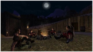 image from gothic classic of 4 characters sitting on the ground around a lit fireplace as they are surrounded by wooden fences and structures at their base, the moon is high in the sky glowing with stars sprinkled throughout the skyline