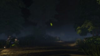 screenshot from the spawn point in bigfoot as the player stands in a dark forest, with a singular leaf falling down to the ground, the trees are covered in fog as flowery bushes adorn the sides of the dirt path