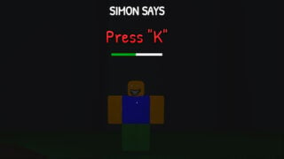 screenshot of a scary roblox default character with a wide grin and white eyes as text appears above him saying 'simon says, press K', the latter half in red, with a timer bar underneath that's about halfway empty