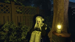 screenshot of a roblox character sat in a plastic chair outside by a metal barrel that has a lantern on top, there is a wooden fence behind them, with some bushes in front, and a tree behind the metal barrel