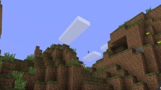 Screenshot from Minecraft with the wonderland.jar mod running. It shows a view over some grassy hills, with a figure floating in the air. It looks like the default Steve model, but with a censored-out face.