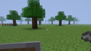 Screenshot from wonderland.jar showing a view of a landscape with trees arranged in a grid pattern. A tall, headless figure stands a distance away, in the fog.