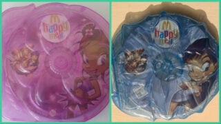 Two of the McDonald's Fairies and Dragons CD-ROMs in their decorated cases. On the left is Violet and on the right is Lily.